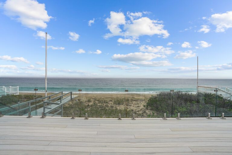 Design Build Services Custom clear glass rail system overlooking the ocean - Westerly RI beach house.
